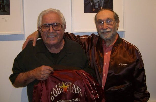 Stan and Dave smiling together with their original custom Gold Star satin jackets at the Grammy Museum